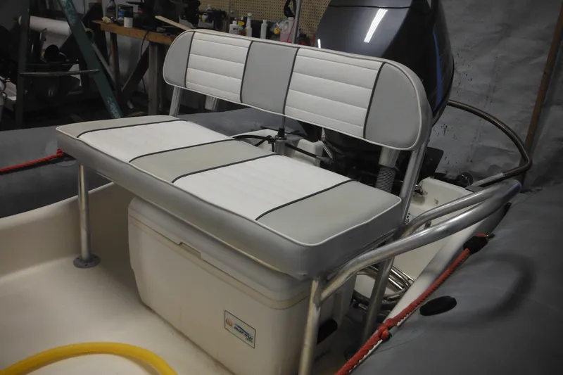 Slide: The Image of 2014 Zodiac Pro 550 boat interior with cushioned seating and storage. - 9