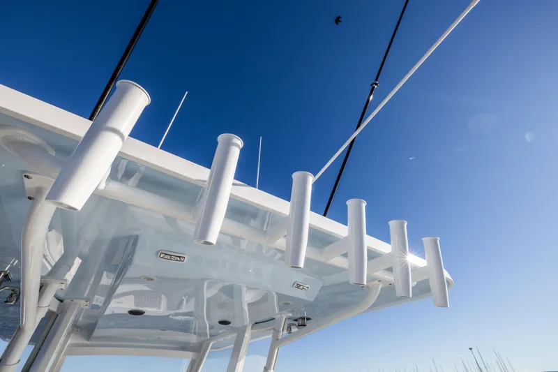 Slide: The Image of 2026 Invincible 38 Catamaran with rod holders against clear blue sky. - 15