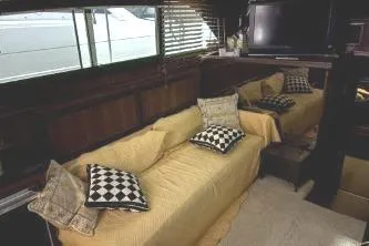 Slide: The Image of Interior of 1977 Hatteras 43 Double Cabin with cozy seating and decorative pillows. - 11