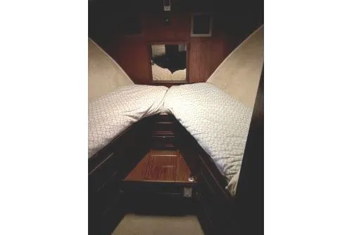 Slide: The Image of 1977 Hatteras 43 Double Cabin interior with twin beds and wooden accents. - 16
