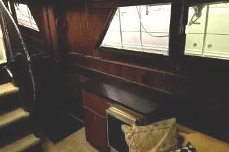 Slide: The Image of 1977 Hatteras 43 Double Cabin interior with wood paneling and windows. - 19