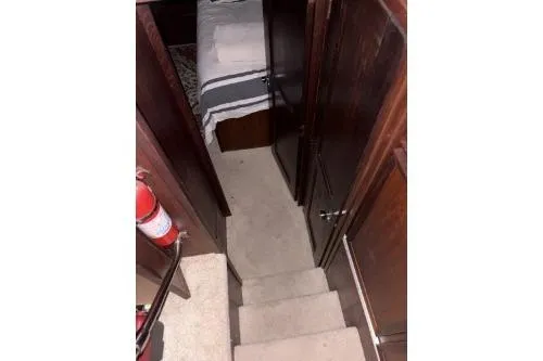 Slide: The Image of 1977 Hatteras 43 Double Cabin interior with stairs and hallway view. - 20