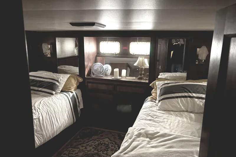 Slide: The Image of Cozy cabin interior of 1977 Hatteras 43 Double Cabin with twin beds and nautical decor. - 22