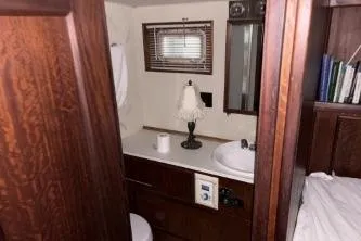Slide: The Image of 1977 Hatteras 43 Double Cabin bathroom with wooden cabinetry and sink. - 24