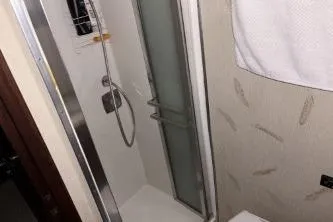 Slide: The Image of 1977 Hatteras 43 Double Cabin bathroom with shower and towel rack. - 25