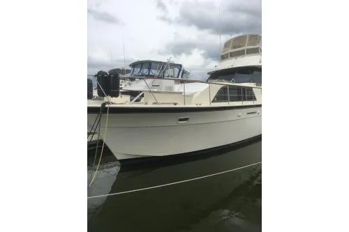 Slide: The Image of 1977 Hatteras 43 Double Cabin yacht docked on a cloudy day. - 3