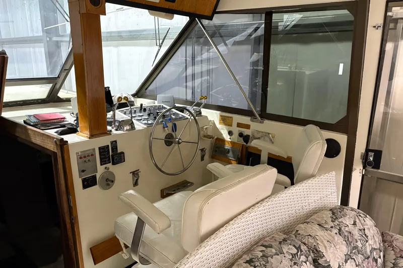 Slide: The Image of 1977 Hatteras 43 Double Cabin helm with steering wheel, controls, and seating. - 7