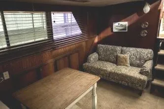 Slide: The Image of Interior of 1977 Hatteras 43 Double Cabin with sofa, table, and window blinds. - 9