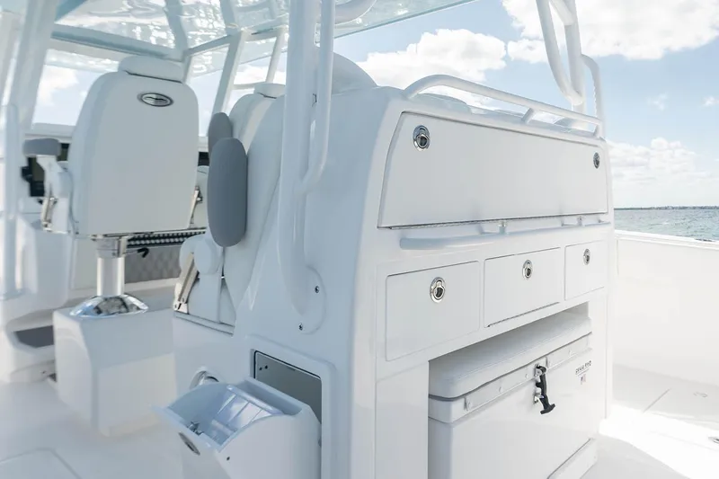 Slide: The Image of Manufacturer Provided Image: 2026 Invincible 40 Catamaran interior with seating and storage, featuring sleek white design. - 6