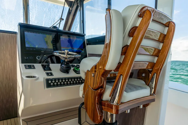 Slide: The Image of Pilothouse interior of 2026 Invincible 46, featuring luxurious helm and advanced navigation displays. - 10