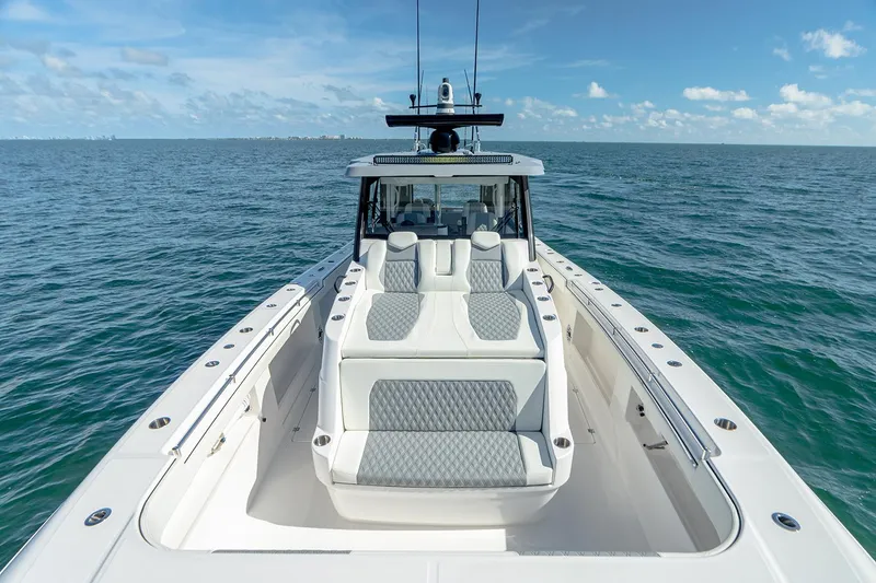 Slide: The Image of Manufacturer Provided Image: 2026 Invincible 46 Pilothouse yacht on open sea under clear blue sky. - 4