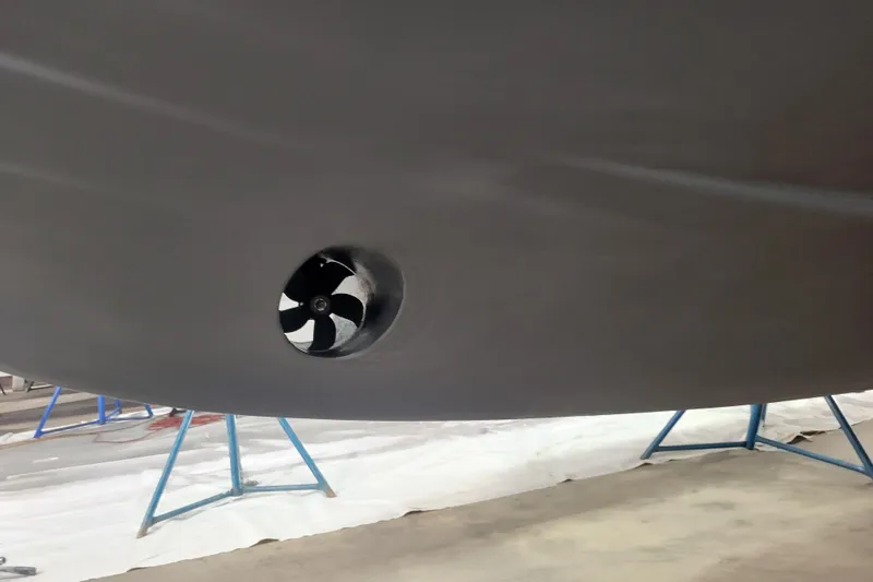 Slide: The Image of 2020 Steiger Craft 31 Miami boat hull with visible thruster, supported on stands. - 11