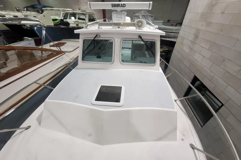Slide: The Image of 2020 Steiger Craft 31 Miami boat in indoor storage, featuring a Simrad radar. - 12