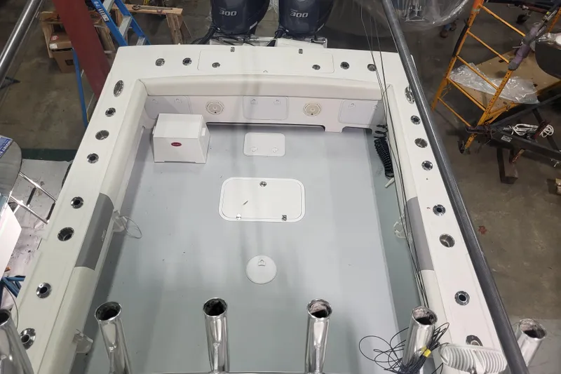 Slide: The Image of 2020 Steiger Craft 31 Miami boat deck with fishing rod holders and storage compartments. - 14