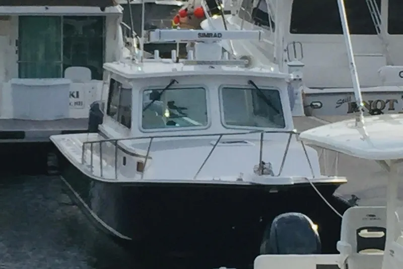 Slide: The Image of 2020 Steiger Craft 31 Miami boat docked among other vessels. - 2