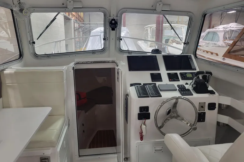 Slide: The Image of 2020 Steiger Craft 31 Miami boat interior with helm, seating, and navigation equipment. - 23