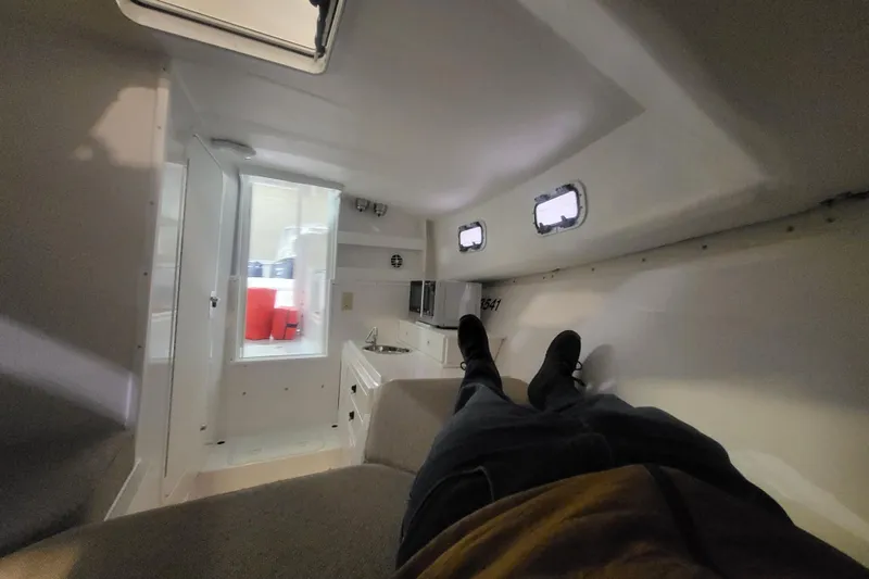 Slide: The Image of Interior cabin of 2020 Steiger Craft 31 Miami boat, featuring compact design and windows. - 25