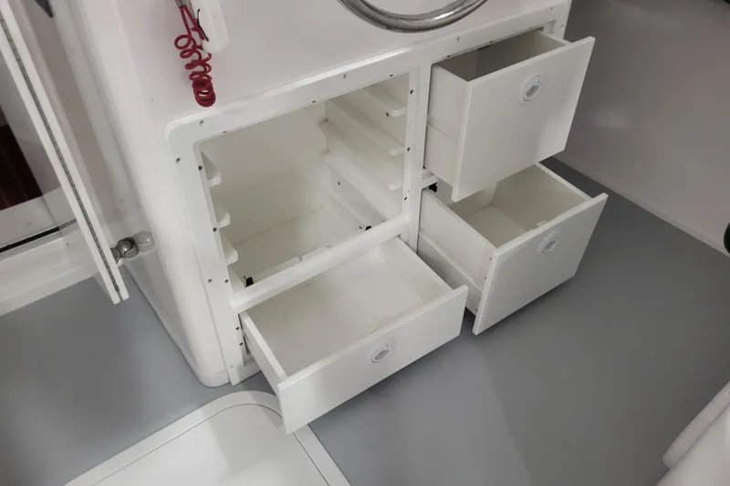 Slide: The Image of Open storage drawers on a 2020 Steiger Craft 31 Miami boat interior. - 31
