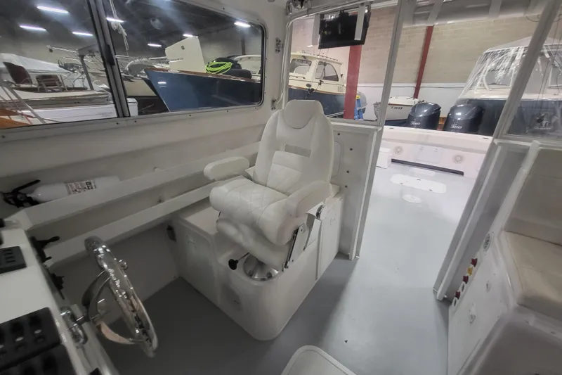 Slide: The Image of Interior of 2020 Steiger Craft 31 Miami boat with captain's chair and control panel. - 33
