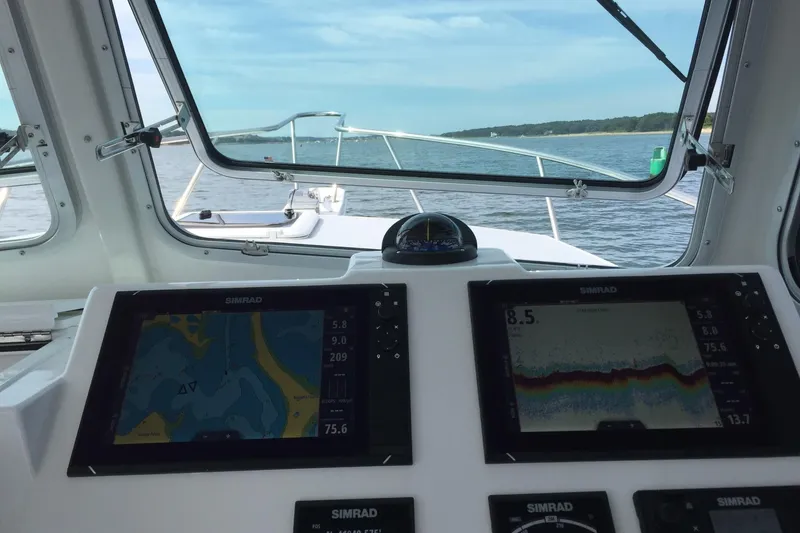 Slide: The Image of Steiger Craft 31 Miami 2020 boat cockpit with navigation screens and open water view. - 4