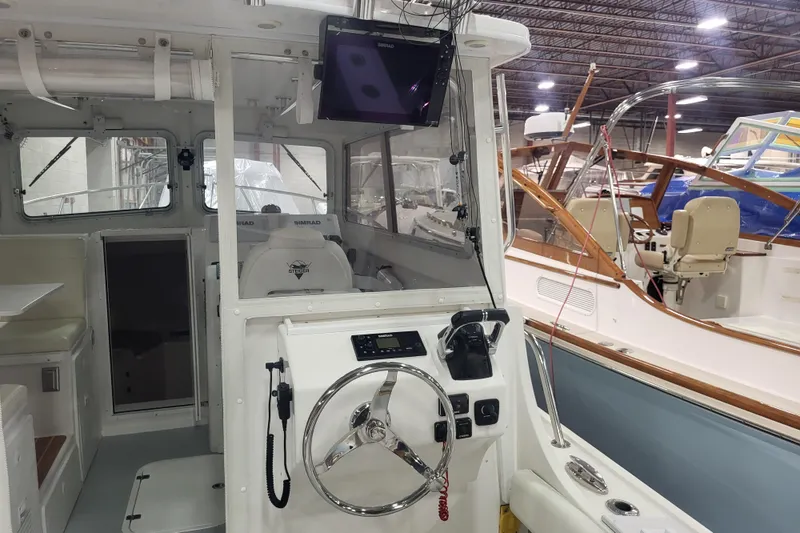Slide: The Image of Interior of 2020 Steiger Craft 31 Miami boat with steering wheel and seating. - 40