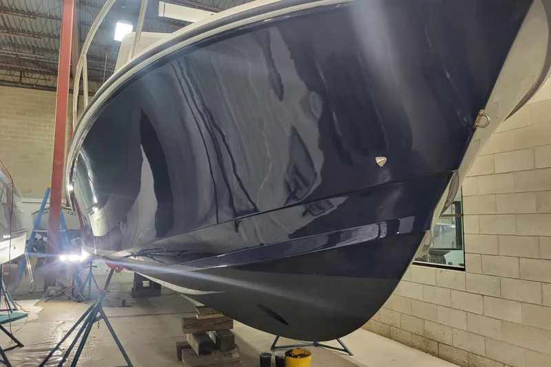 Slide: The Image of 2020 Steiger Craft 31 Miami boat in a workshop, showcasing sleek blue hull design. - 6