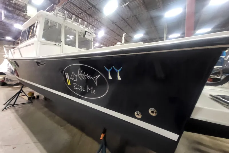 Slide: The Image of 2020 Steiger Craft 31 Miami boat with "Bite Me" graphic in indoor storage. - 7