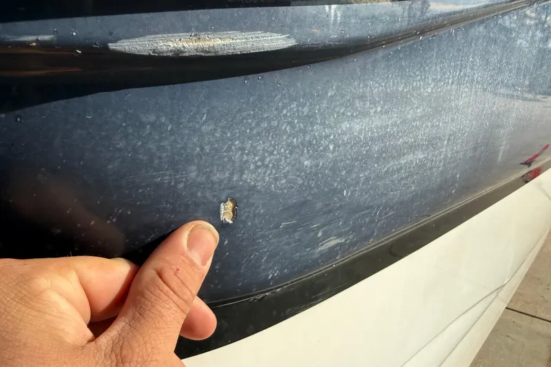 Slide: The Image of Close-up of a 2015 Hurricane SunDeck 2000 OB boat hull with a small chip. - 13