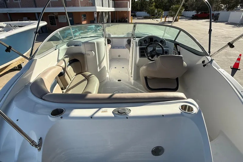 Slide: The Image of 2015 Hurricane SunDeck 2000 OB boat interior with seating and steering wheel. - 17