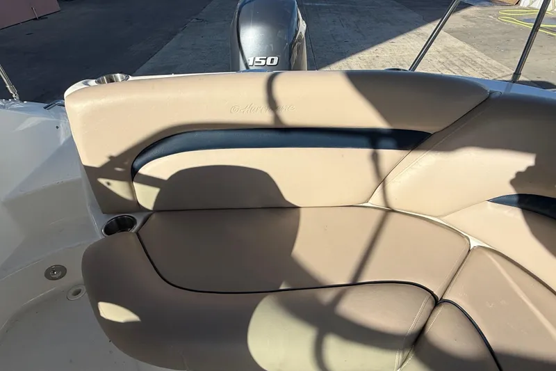 Slide: The Image of 2015 Hurricane SunDeck 2000 OB boat seating with beige upholstery and cup holder. - 22