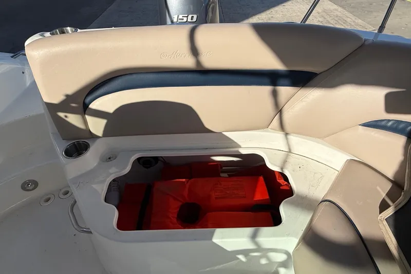 Slide: The Image of 2015 Hurricane SunDeck 2000 OB boat seat storage with life jacket inside. - 23