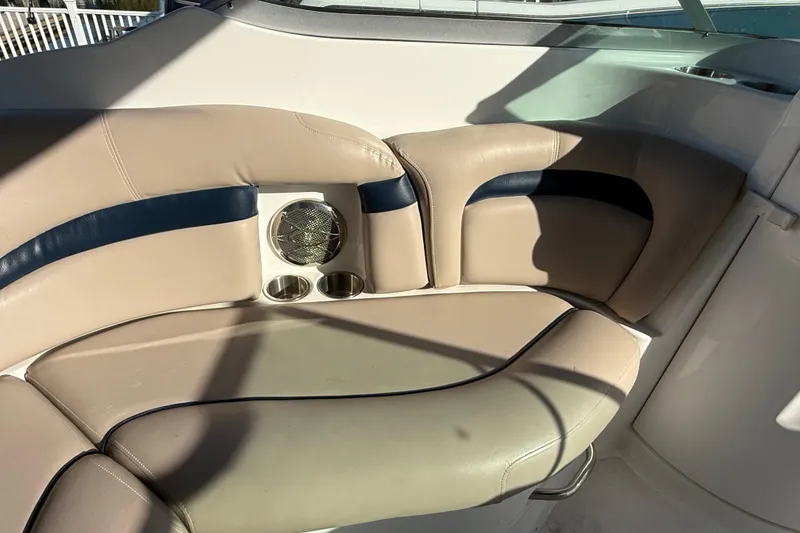 Slide: The Image of 2015 Hurricane SunDeck 2000 OB boat interior with beige seating and cup holders. - 25