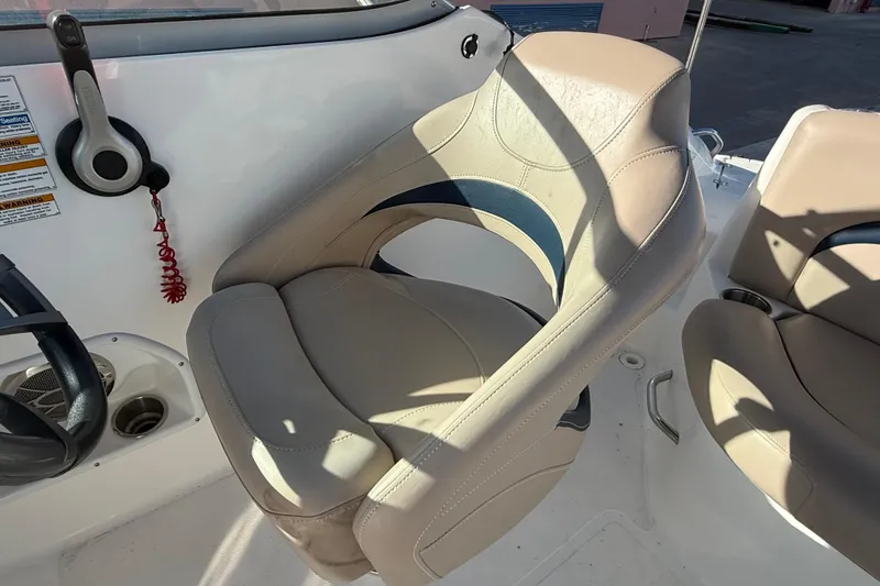 Slide: The Image of 2015 Hurricane SunDeck 2000 OB boat seat and control panel in sunlight. - 27