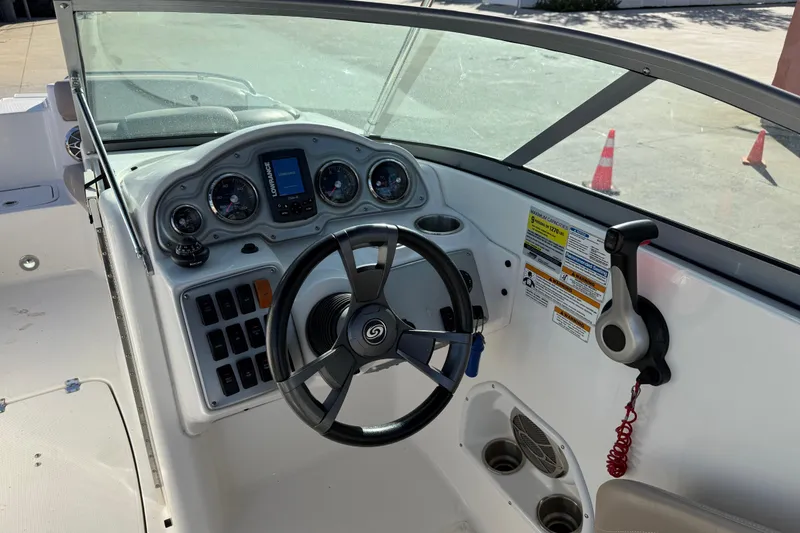 Slide: The Image of 2015 Hurricane SunDeck 2000 OB boat dashboard with steering wheel and control panel. - 28