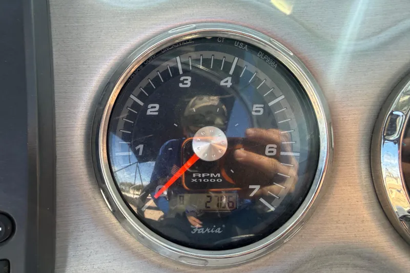 Slide: The Image of Close-up of 2015 Hurricane SunDeck 2000 OB tachometer showing RPM and reflection. - 31