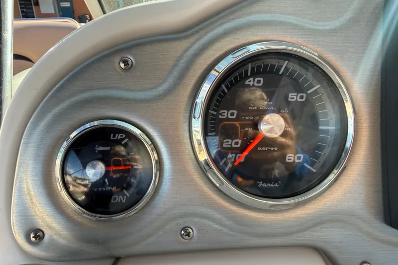 Slide: The Image of Dashboard of 2015 Hurricane SunDeck 2000 OB boat with speedometer and trim gauge. - 32