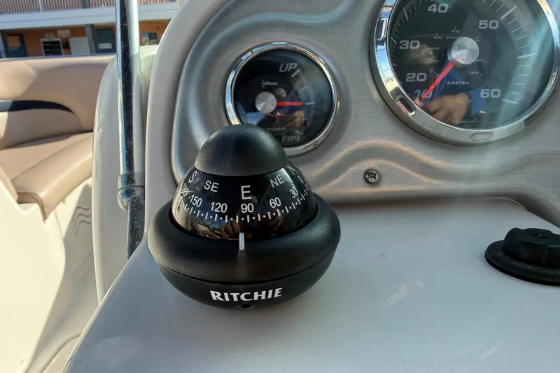 Slide: The Image of Dashboard of 2015 Hurricane SunDeck 2000 OB with compass and gauges. - 33