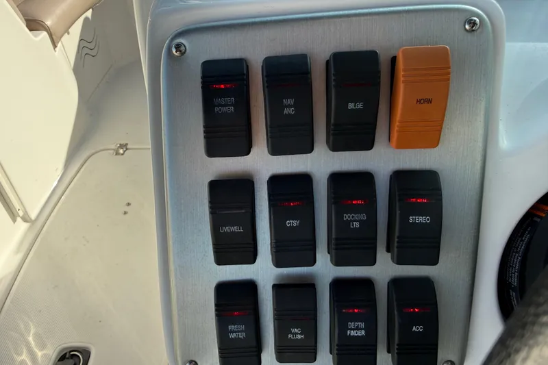Slide: The Image of Control panel of a 2015 Hurricane SunDeck 2000 OB boat with labeled switches. - 34