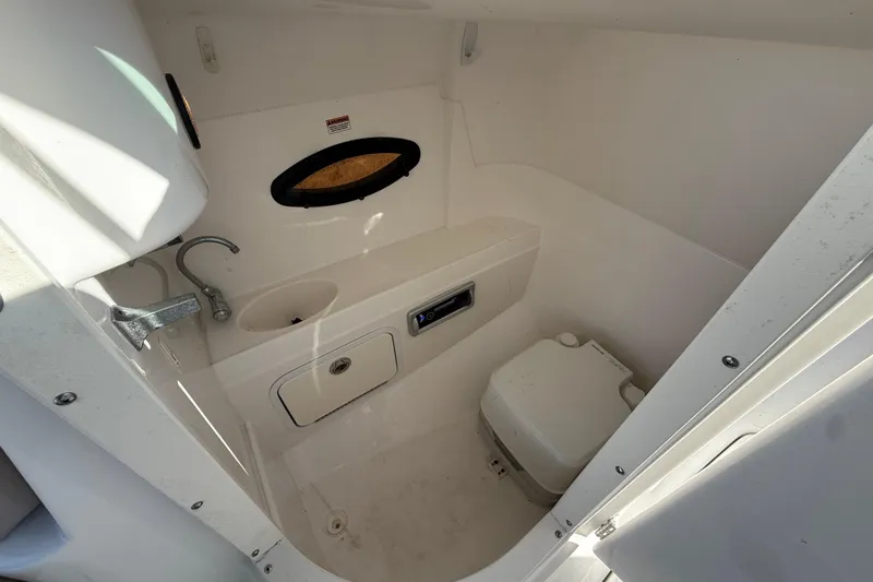 Slide: The Image of 2015 Hurricane SunDeck 2000 OB boat interior with sink and portable toilet. - 36