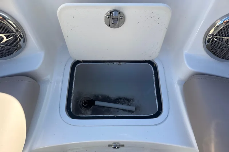 Slide: The Image of 2015 Hurricane SunDeck 2000 OB boat storage compartment with speakers and seating. - 43