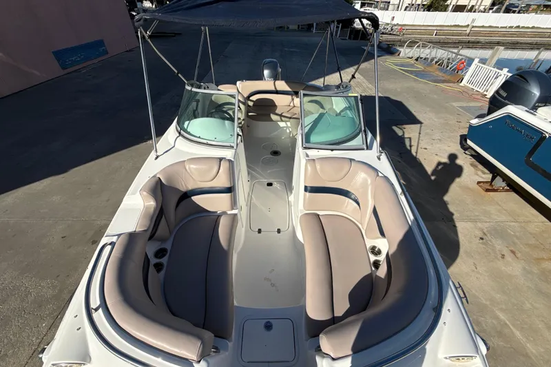 Slide: The Image of 2015 Hurricane SunDeck 2000 OB boat with spacious seating and canopy, docked outdoors. - 45