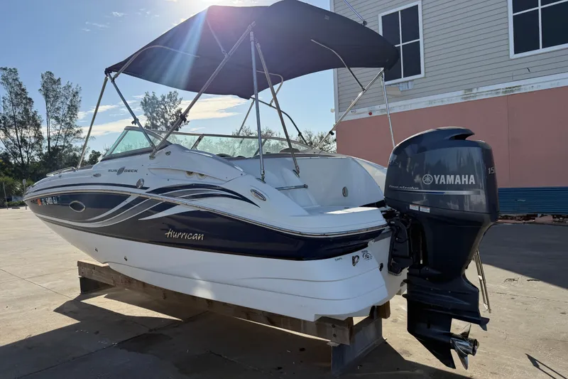 Slide: The Image of 2015 Hurricane SunDeck 2000 OB boat with Yamaha outboard motor, parked outdoors. - 5