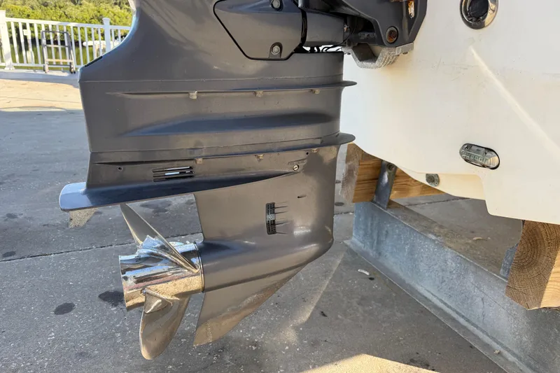 Slide: The Image of 2015 Hurricane SunDeck 2000 OB outboard motor and propeller on a boat trailer. - 8