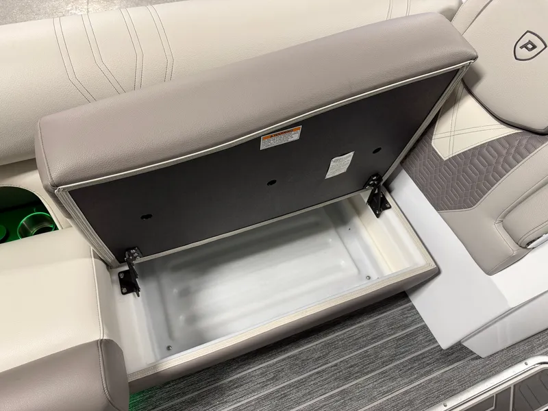Slide: The Image of An open storage compartment on a boat with cushioned seating and gray flooring. - 20