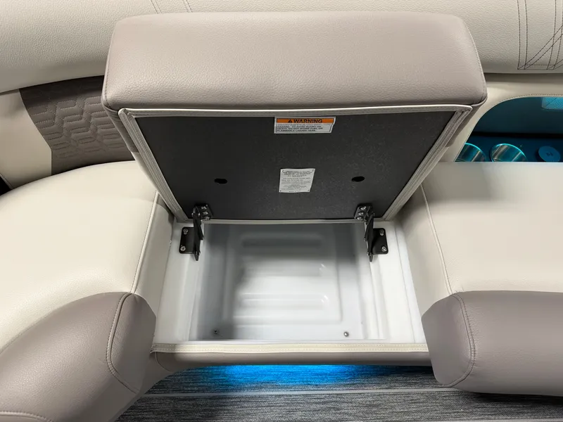Slide: The Image of An open storage compartment in a boat with cushioned seats and blue lighting. - 17