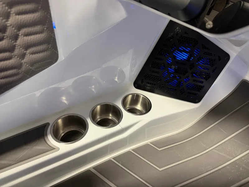 Slide: The Image of Close-up of stainless steel cup holders and a vented compartment with blue lighting. - 49