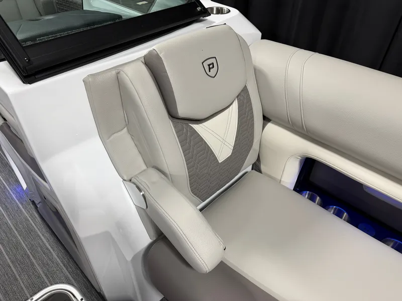 Slide: The Image of Luxurious seat with gray and beige upholstery, armrest, and Premier logo. - 34
