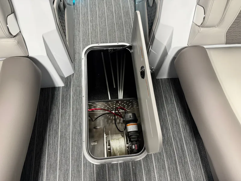 Slide: The Image of An open storage compartment in a boat's floor reveals cables and a pump. - 36