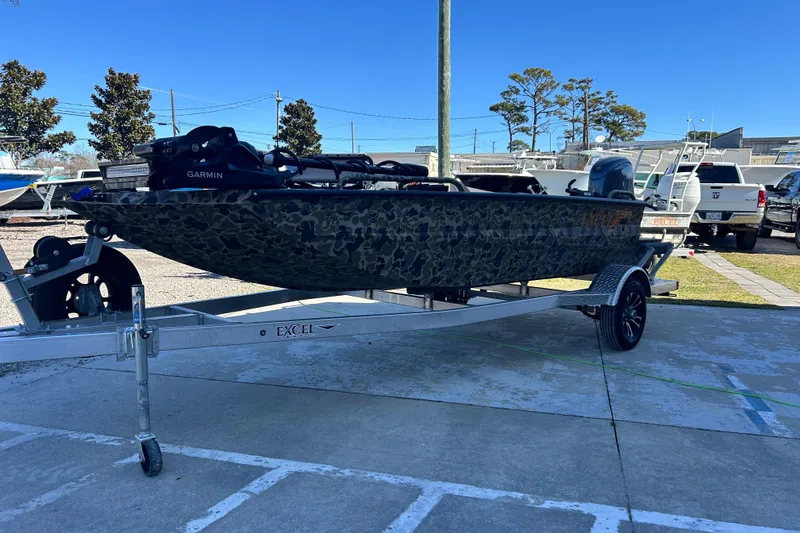 Slide: The Image of 2026 Excel 1751 Viper F4 boat on trailer, camo design, outdoor setting. - 4