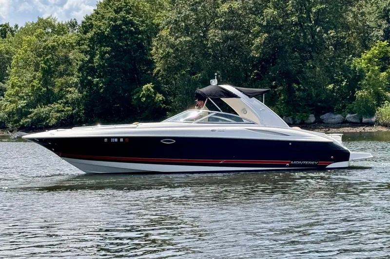 The Image of 2005 Monterey 298SS Super Sport boat cruising on a scenic lake. - 0